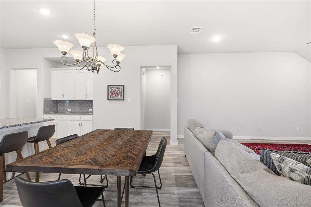 3921 Madison Lane Denton, TX 76208 - Photo 28 of 37 a view of a dining room with furniture and chandelier