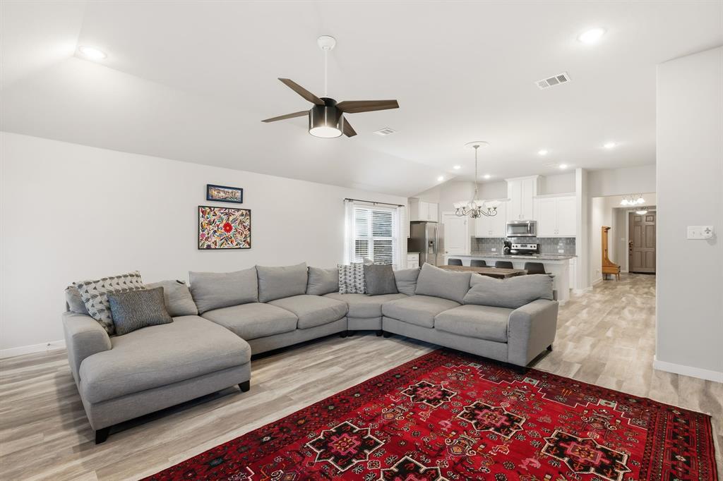 3921 Madison Lane Denton, TX 76208 - Photo 3 of 37 a living room with furniture or kitchen view and a wooden floor