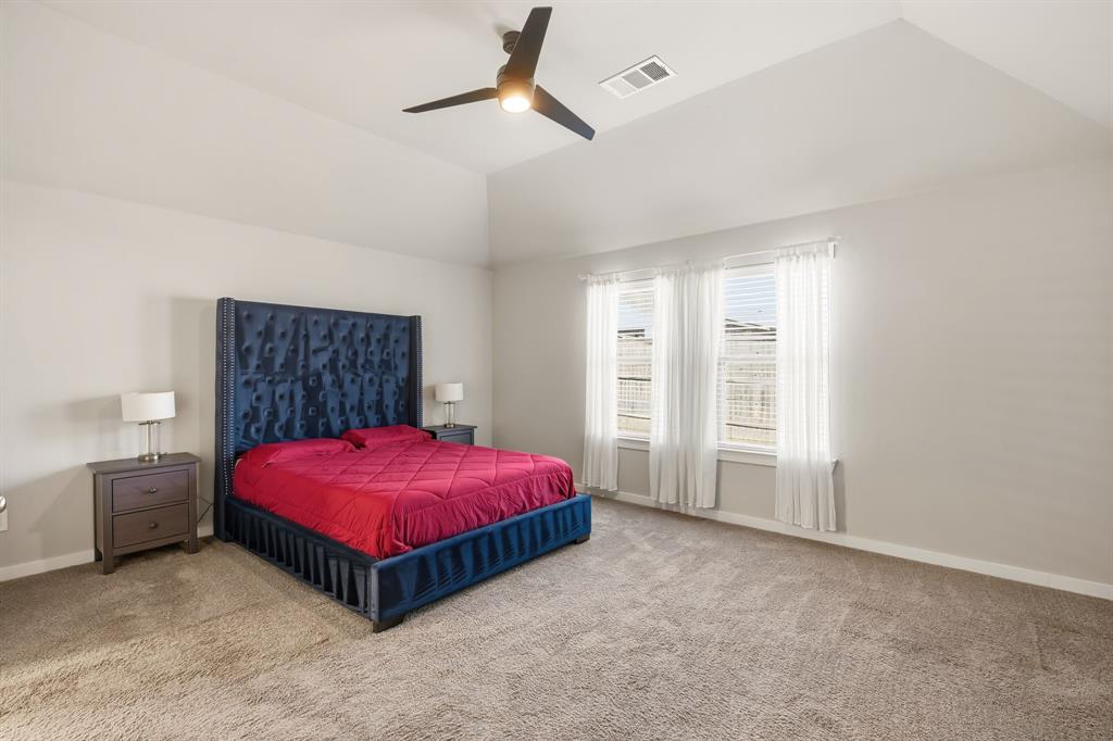 3921 Madison Lane Denton, TX 76208 - Photo 7 of 37 a spacious bedroom with a bed and a table