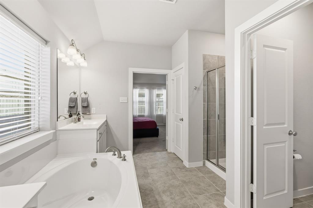 3921 Madison Lane Denton, TX 76208 - Photo 9 of 37 a en suite spacious bathroom with a tub sink and mirror