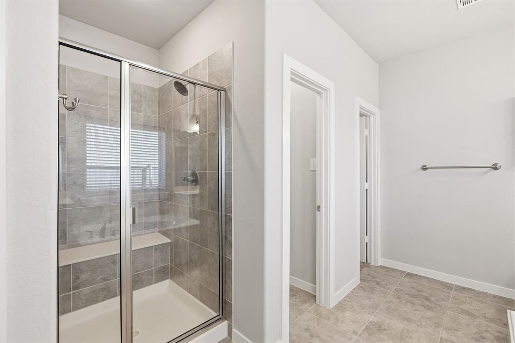 3921 Madison Lane Denton, TX 76208 - Photo 10 of 37 a bathroom that has a glass shower door