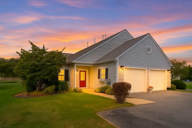 a view of a house with backyard and a tree