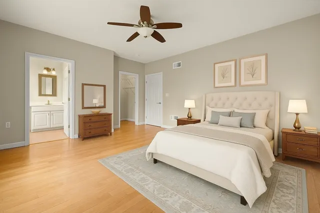 a spacious bedroom with a bed and ceiling fan