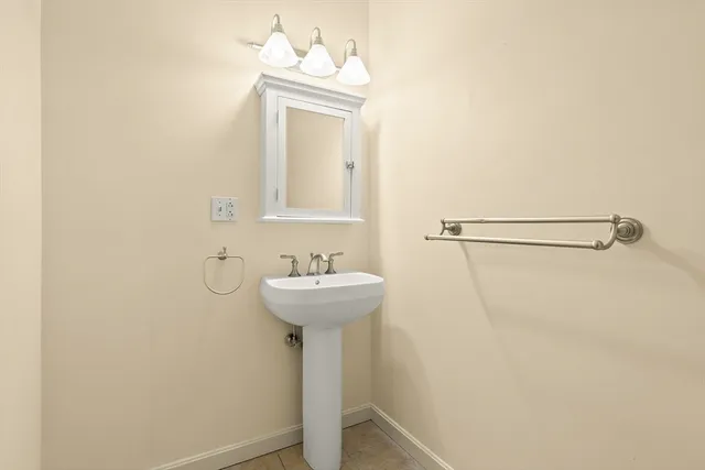 a bathroom with a sink a mirror and shower