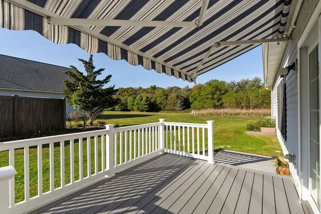 a view of a wooden deck with a yard