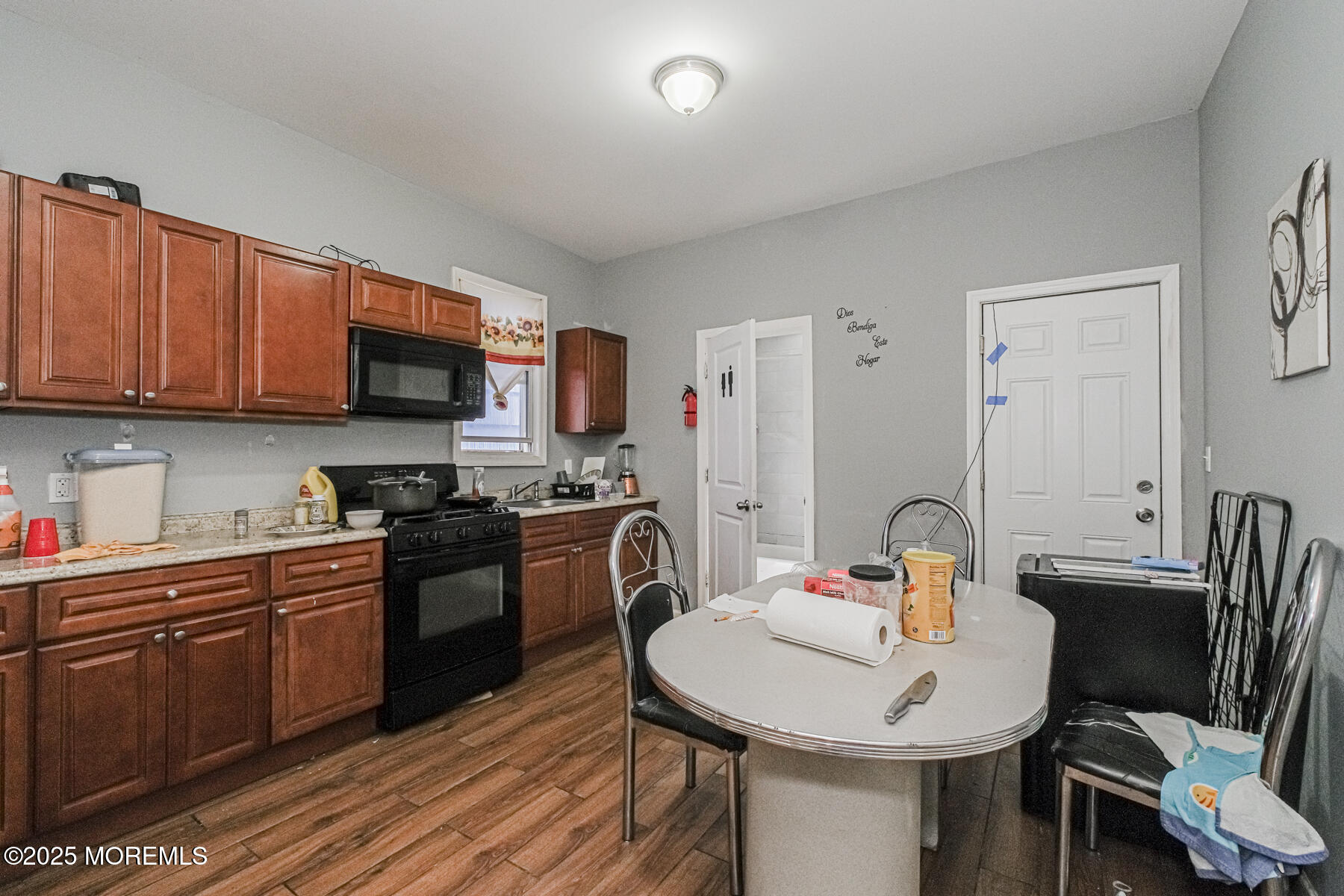16 Alexander Street Newark, NJ 07106 - Photo 21 of 26 a kitchen with stainless steel appliances a sink a stove a table and chairs