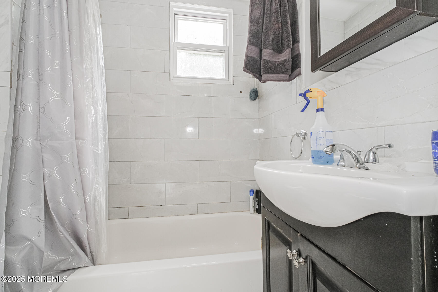 16 Alexander Street Newark, NJ 07106 - Photo 22 of 26 a bathroom with a sink and a bathtub
