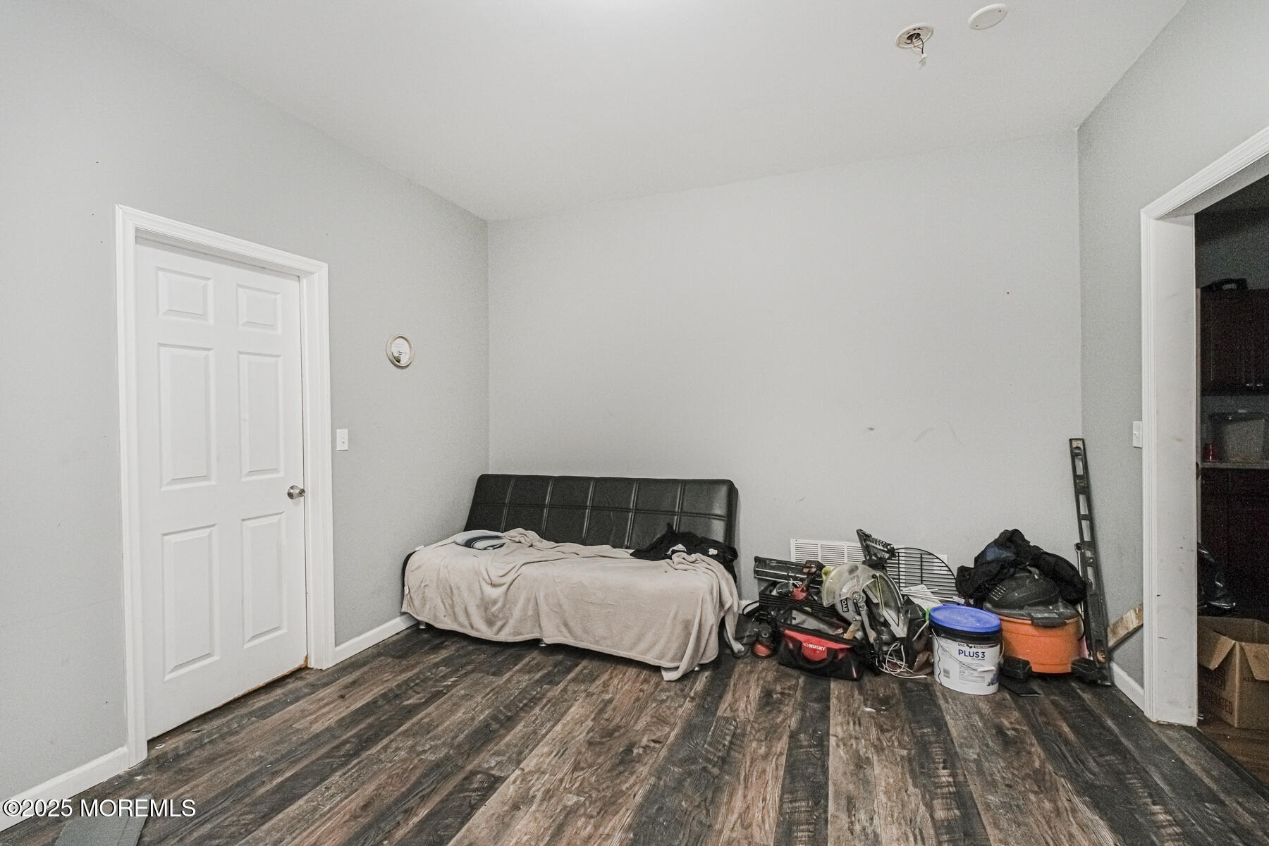 16 Alexander Street Newark, NJ 07106 - Photo 24 of 26 a bedroom with a bed and a wooden floor