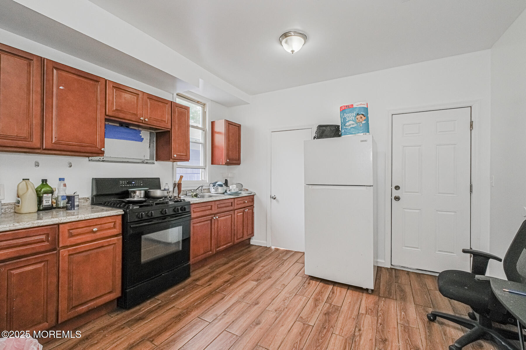 16 Alexander Street Newark, NJ 07106 - Photo 5 of 26 a kitchen with granite countertop wooden floors stainless steel appliances and a sink