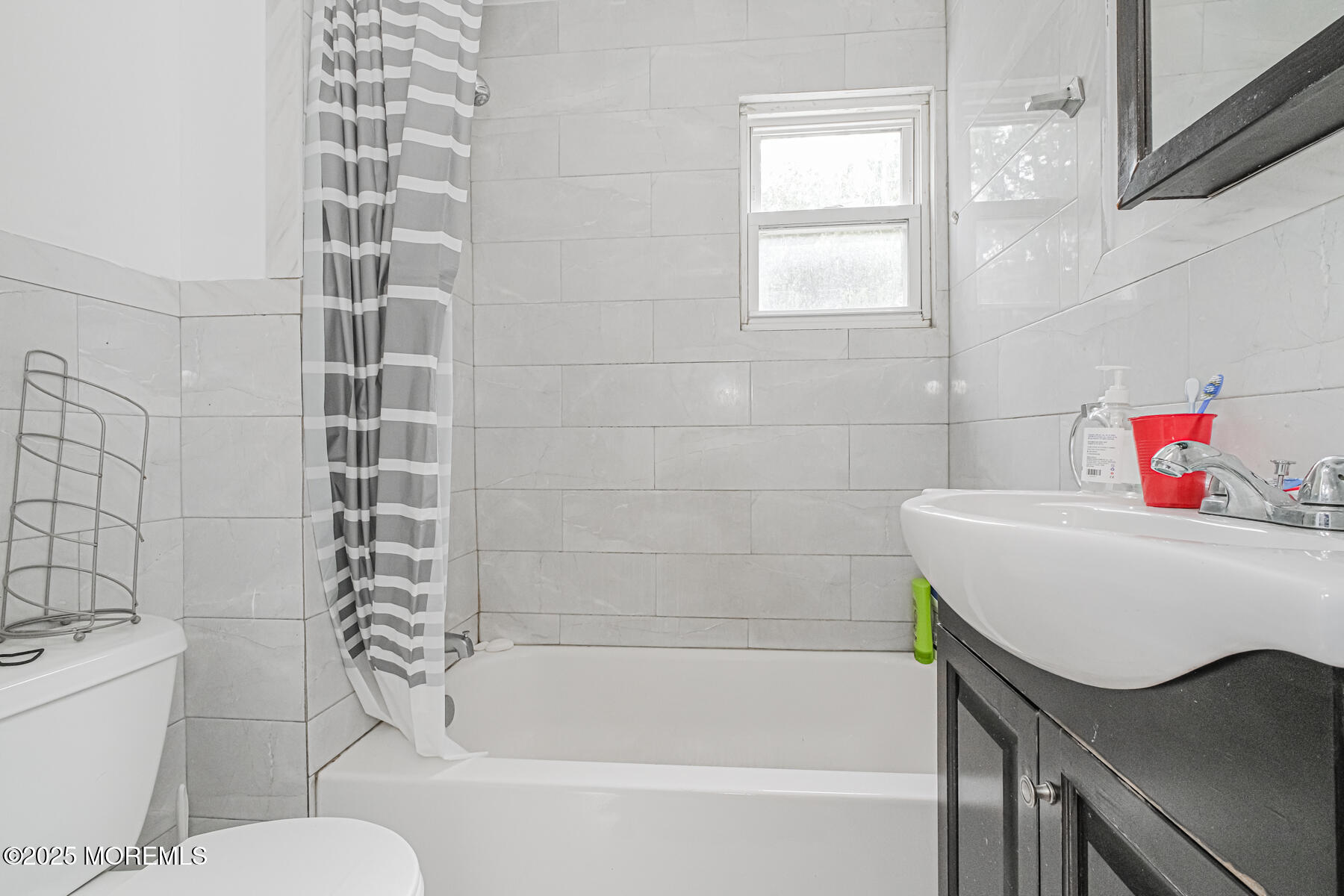16 Alexander Street Newark, NJ 07106 - Photo 9 of 26 a bathroom with a sink and bathtub with toilet