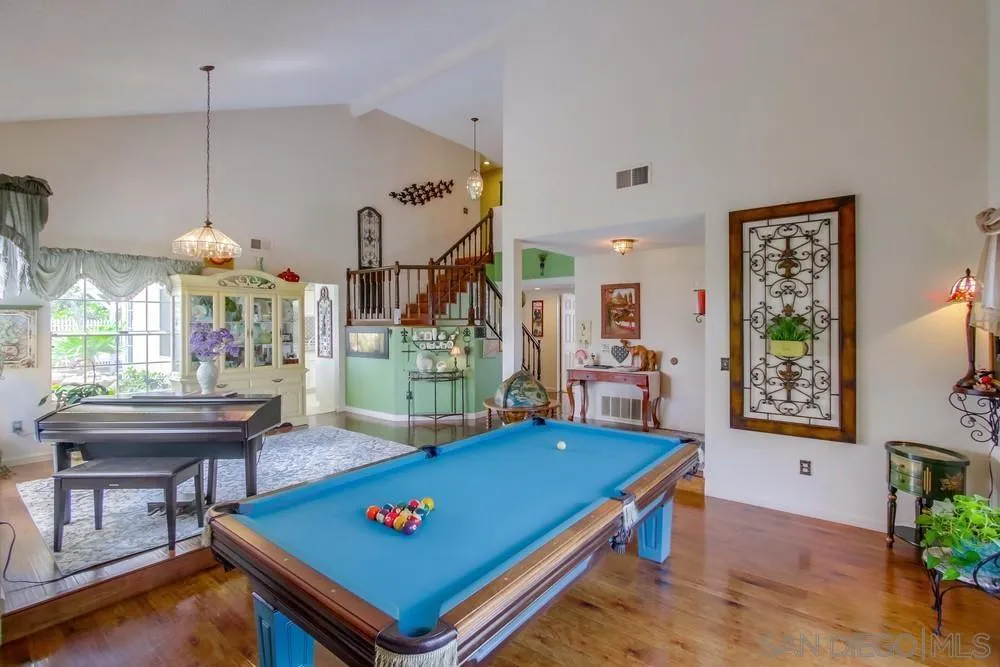 13590 Freeport Road San Diego, CA 92129 - Photo 11 of 58 a living room with furniture pool table and a potted plant