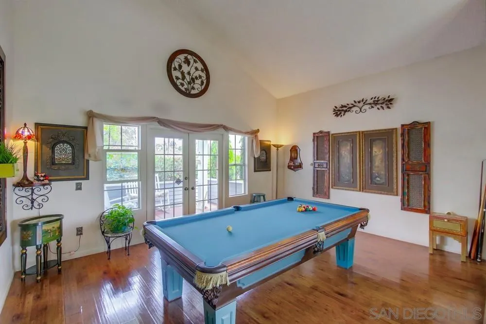 13590 Freeport Road San Diego, CA 92129 - Photo 13 of 58 a living room with pool table and a wooden floor