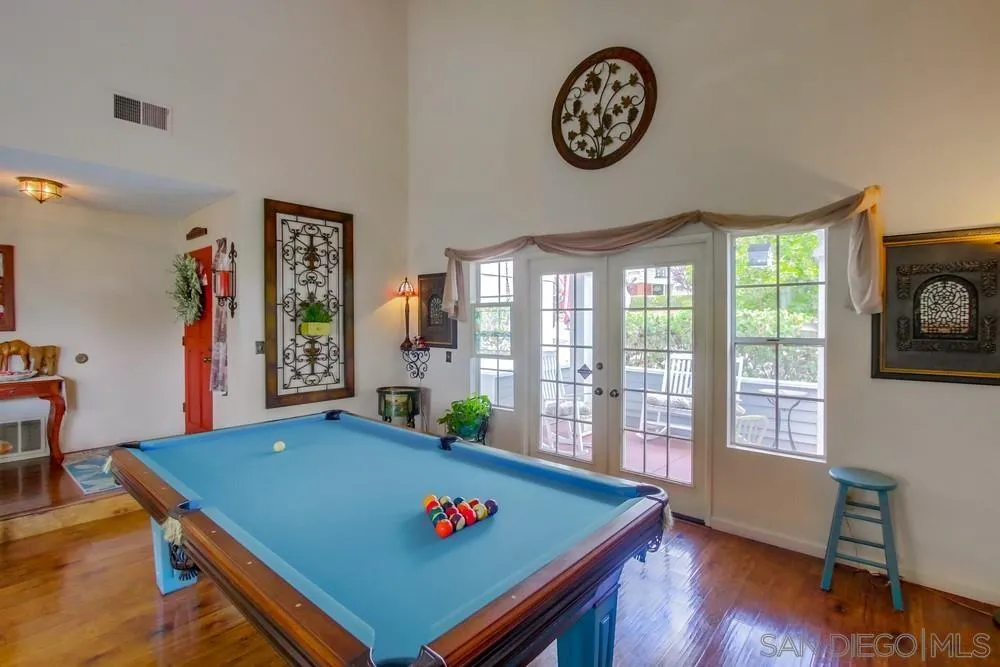 13590 Freeport Road San Diego, CA 92129 - Photo 14 of 58 a view of a dining room with furniture a chandelier and wooden floor