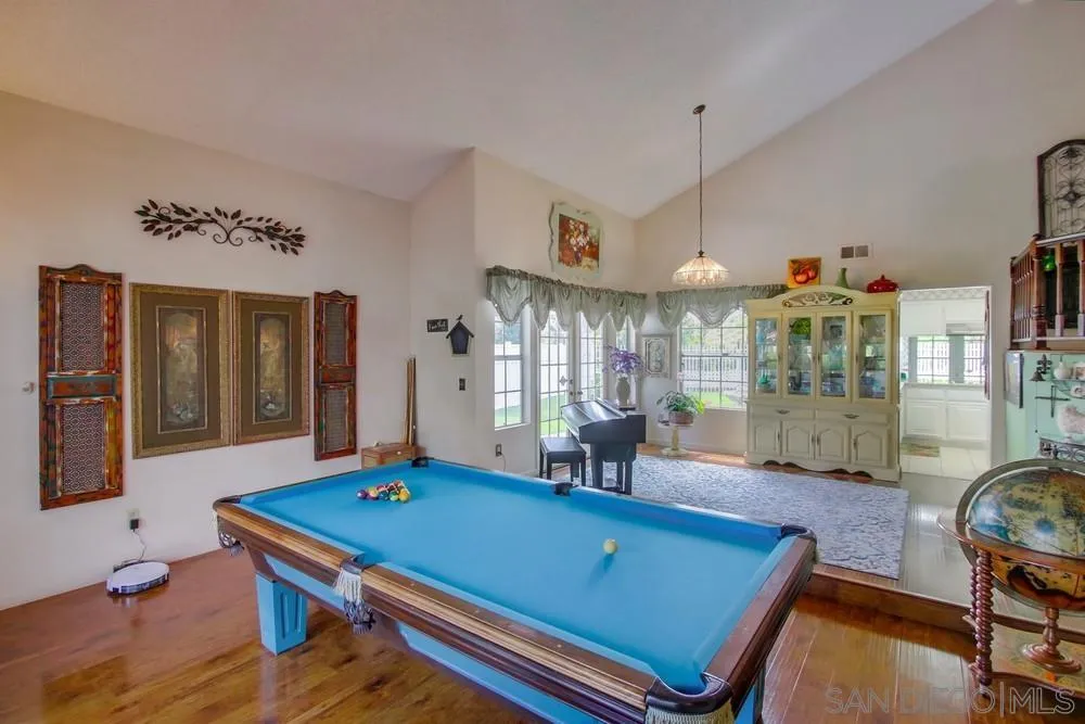 13590 Freeport Road San Diego, CA 92129 - Photo 15 of 58 a living room with furniture pool table and chandelier