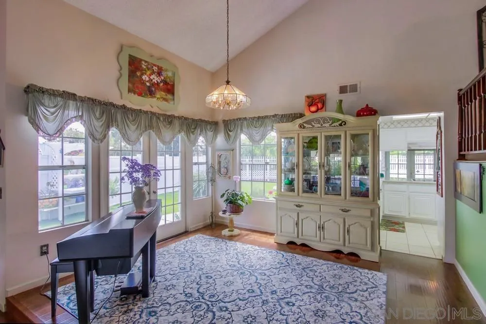 13590 Freeport Road San Diego, CA 92129 - Photo 16 of 58 a view of a dining room with furniture window and wooden floor