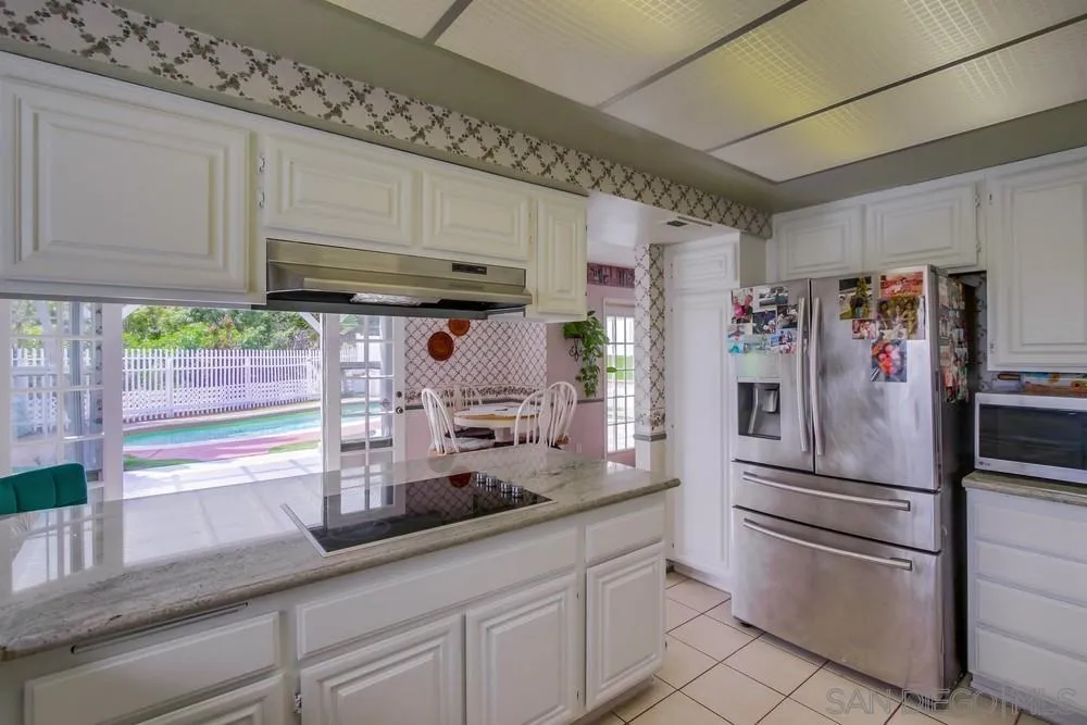 13590 Freeport Road San Diego, CA 92129 - Photo 18 of 58 a kitchen with granite countertop stainless steel appliances and counter space
