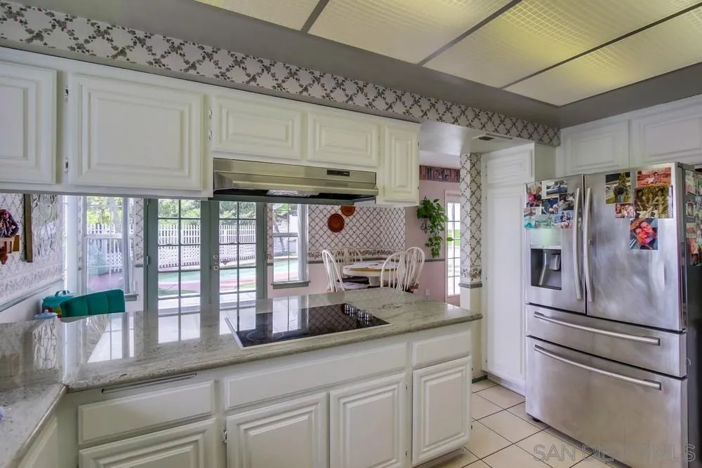 13590 Freeport Road San Diego, CA 92129 - Photo 19 of 58 a kitchen with granite countertop stainless steel appliances a sink and cabinets