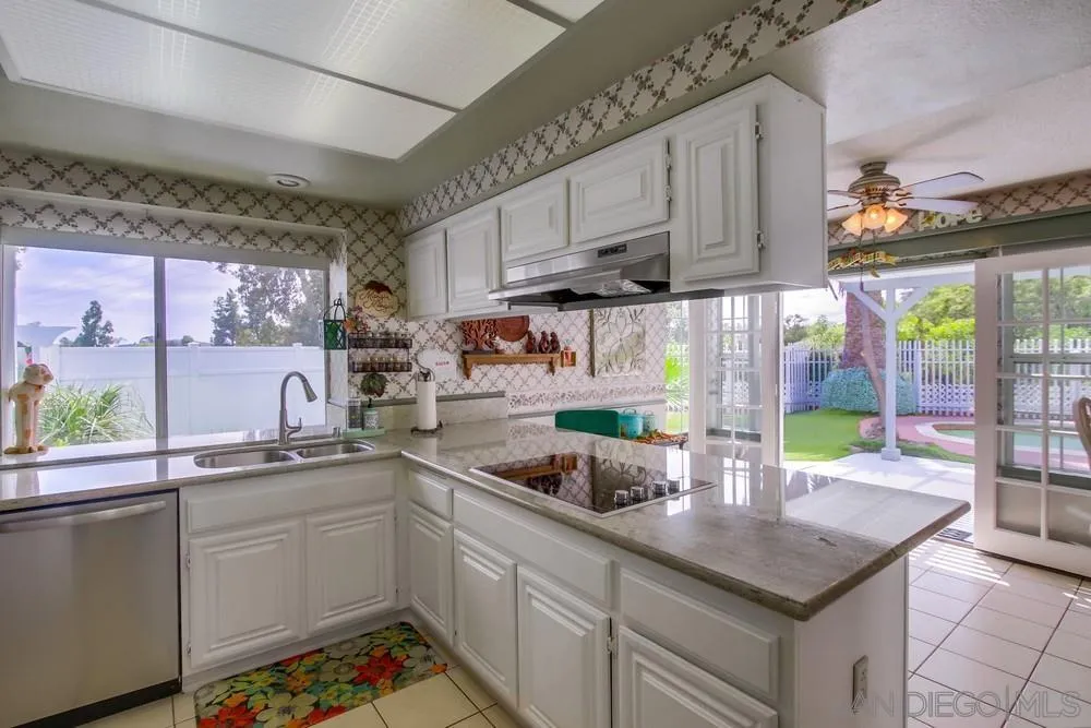 13590 Freeport Road San Diego, CA 92129 - Photo 20 of 58 a kitchen with stainless steel appliances granite countertop a sink a stove and a counter space