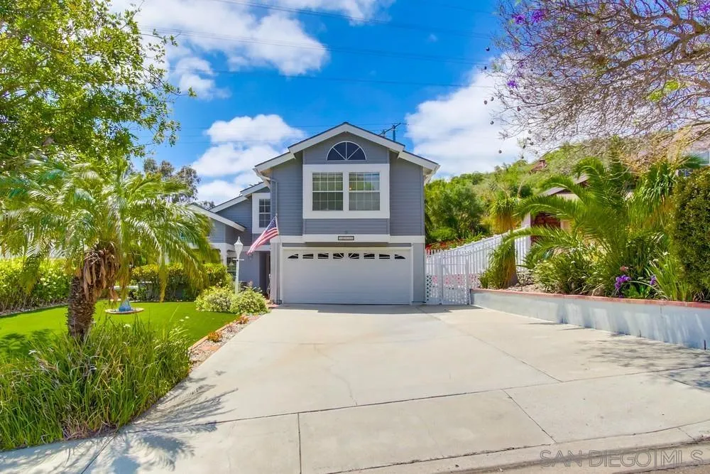 13590 Freeport Road San Diego, CA 92129 - Photo 2 of 58 a front view of a house with a yard and garage
