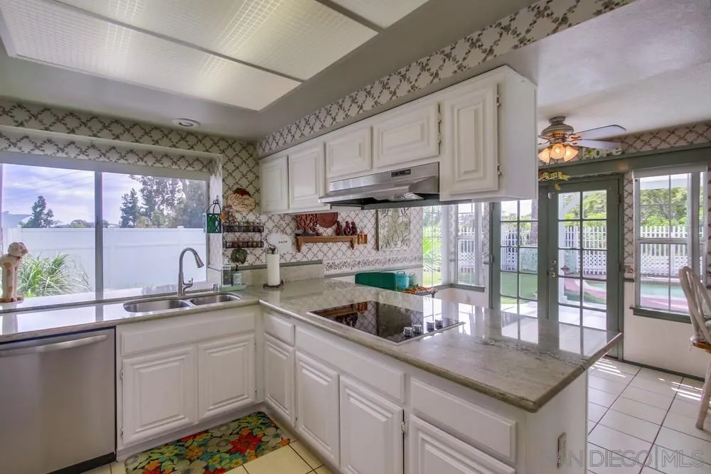 13590 Freeport Road San Diego, CA 92129 - Photo 21 of 58 a kitchen with stainless steel appliances granite countertop a sink window and cabinets