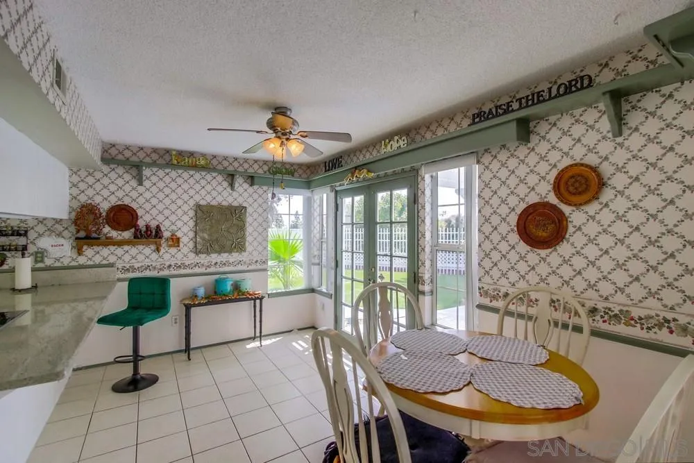 13590 Freeport Road San Diego, CA 92129 - Photo 23 of 58 a view of a dining room with furniture and chandelier
