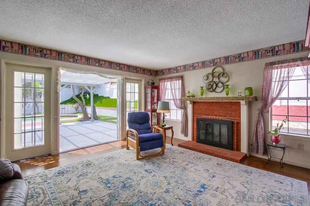 13590 Freeport Road San Diego, CA 92129 - Photo 26 of 58 a living room with furniture and a fireplace