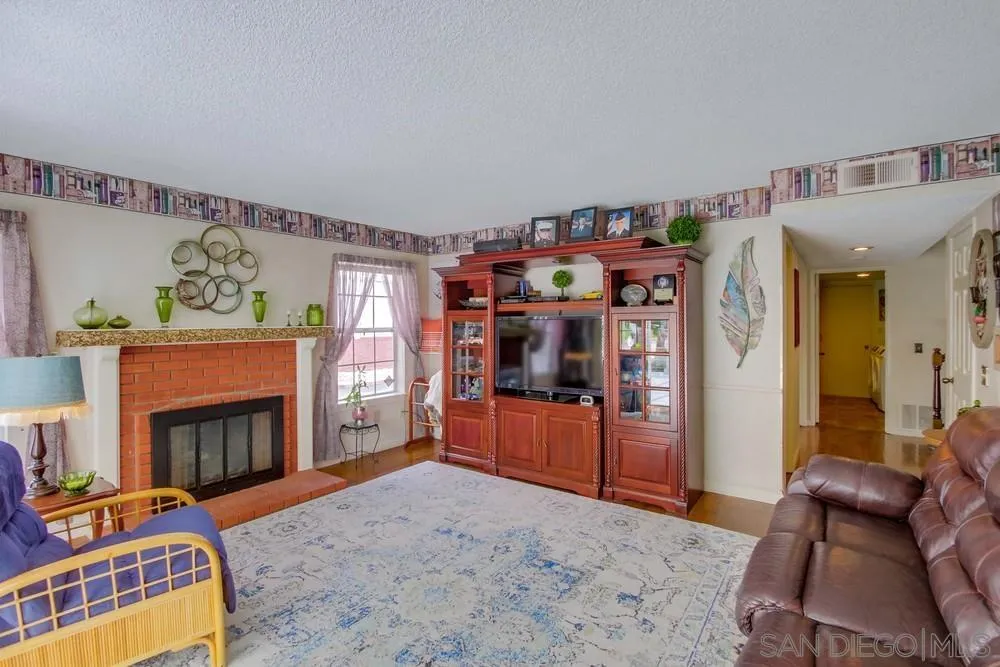 13590 Freeport Road San Diego, CA 92129 - Photo 27 of 58 a living room with furniture and a fireplace