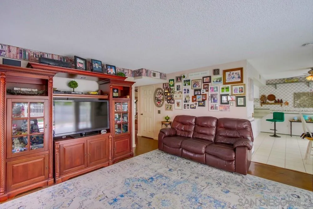 13590 Freeport Road San Diego, CA 92129 - Photo 28 of 58 a living room with furniture and a flat screen tv