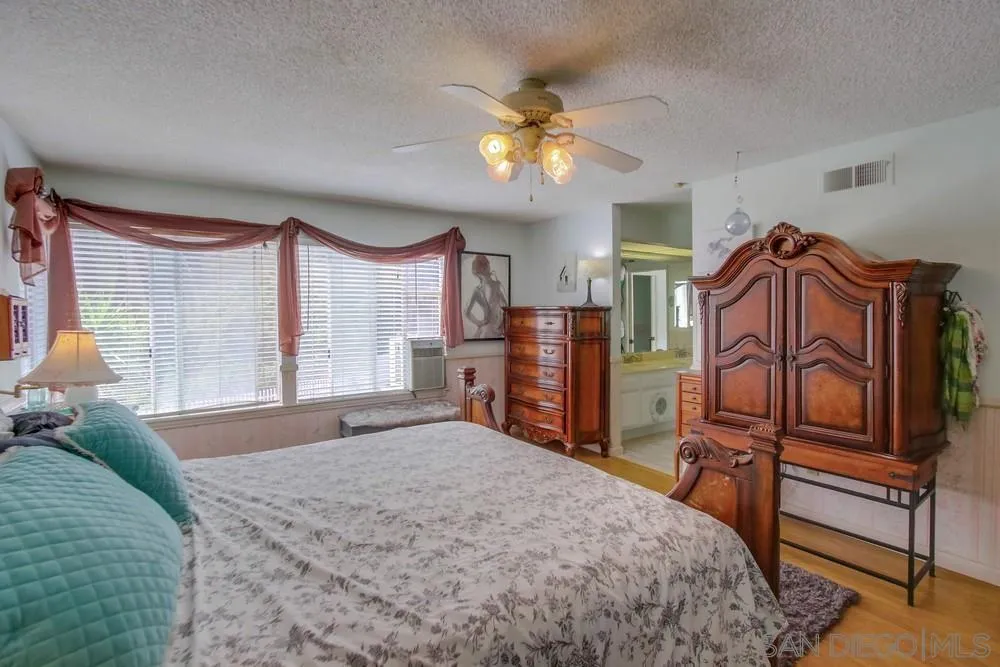 13590 Freeport Road San Diego, CA 92129 - Photo 37 of 58 a bedroom with a bed dresser and a window