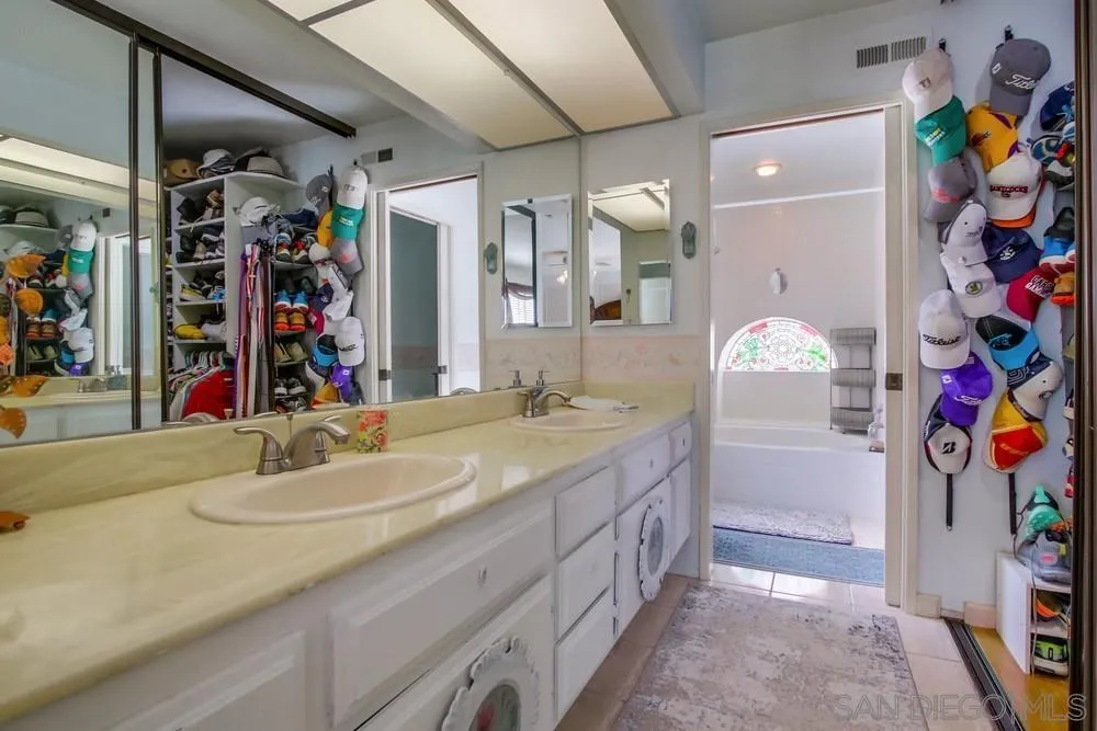 13590 Freeport Road San Diego, CA 92129 - Photo 39 of 58 a bathroom with a sink a vanity and a mirror