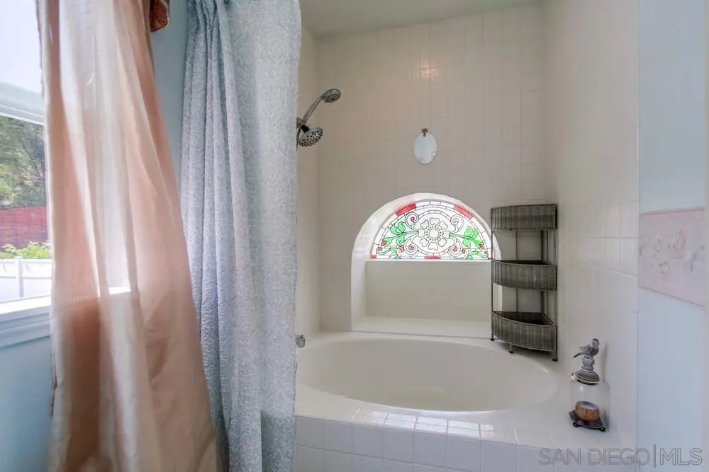 13590 Freeport Road San Diego, CA 92129 - Photo 40 of 58 a bathroom with a bathtub and shower