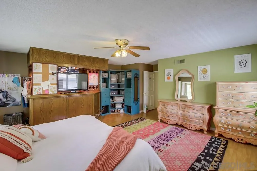 13590 Freeport Road San Diego, CA 92129 - Photo 47 of 58 a bedroom with a bed dresser and a large window