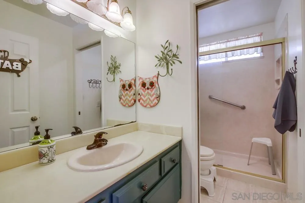 13590 Freeport Road San Diego, CA 92129 - Photo 48 of 58 a bathroom with a sink a toilet and a mirror