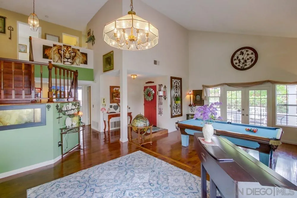 13590 Freeport Road San Diego, CA 92129 - Photo 10 of 58 a living room with lots of furniture and a chandelier