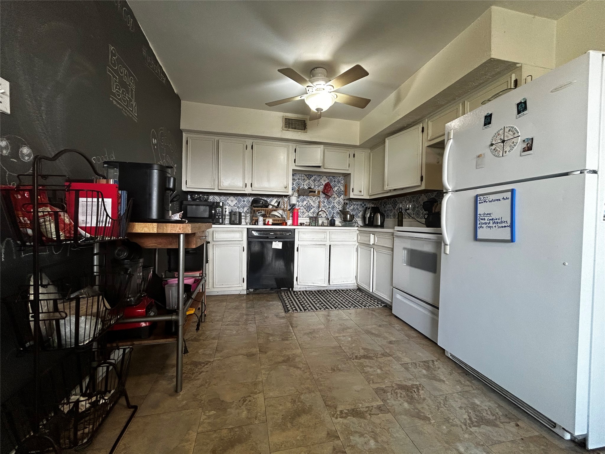 4511 Avenue B, Unit B Austin, TX 78751 - Photo 2 of 15 Kitchen with black appliances, light countertops, ceiling fan, and backsplash