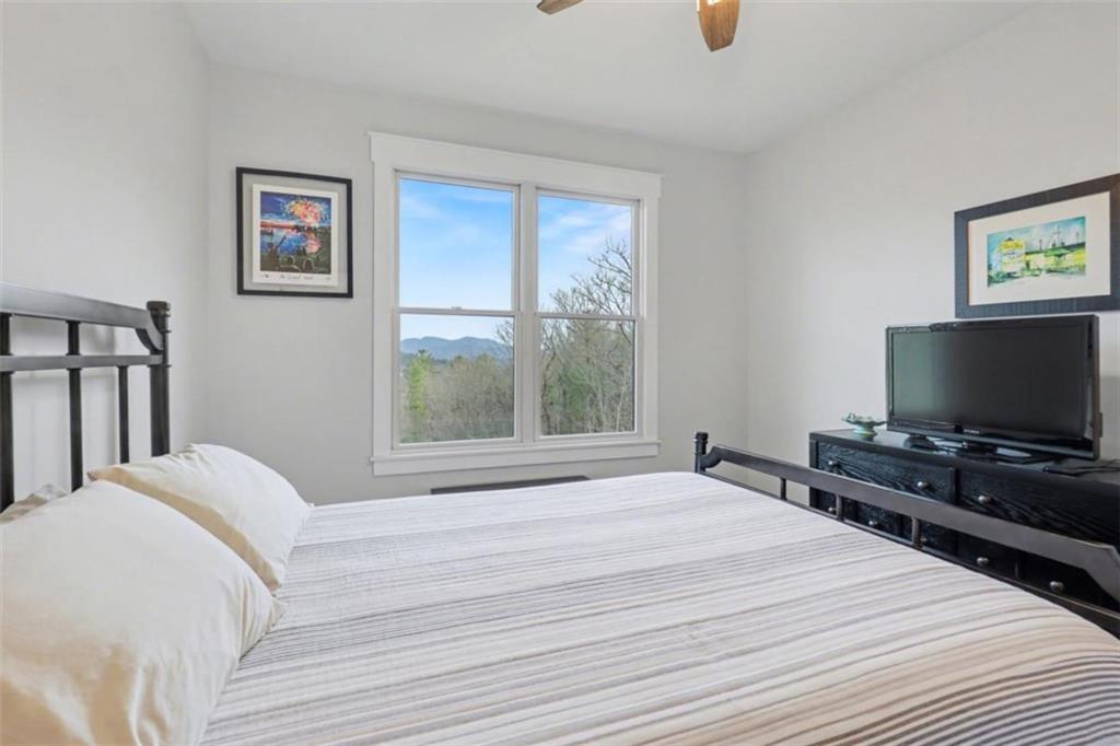 452 Chestnut Mountain Road Blairsville, GA 30512 - Photo 21 of 77 a bedroom with a bed and a flat screen tv