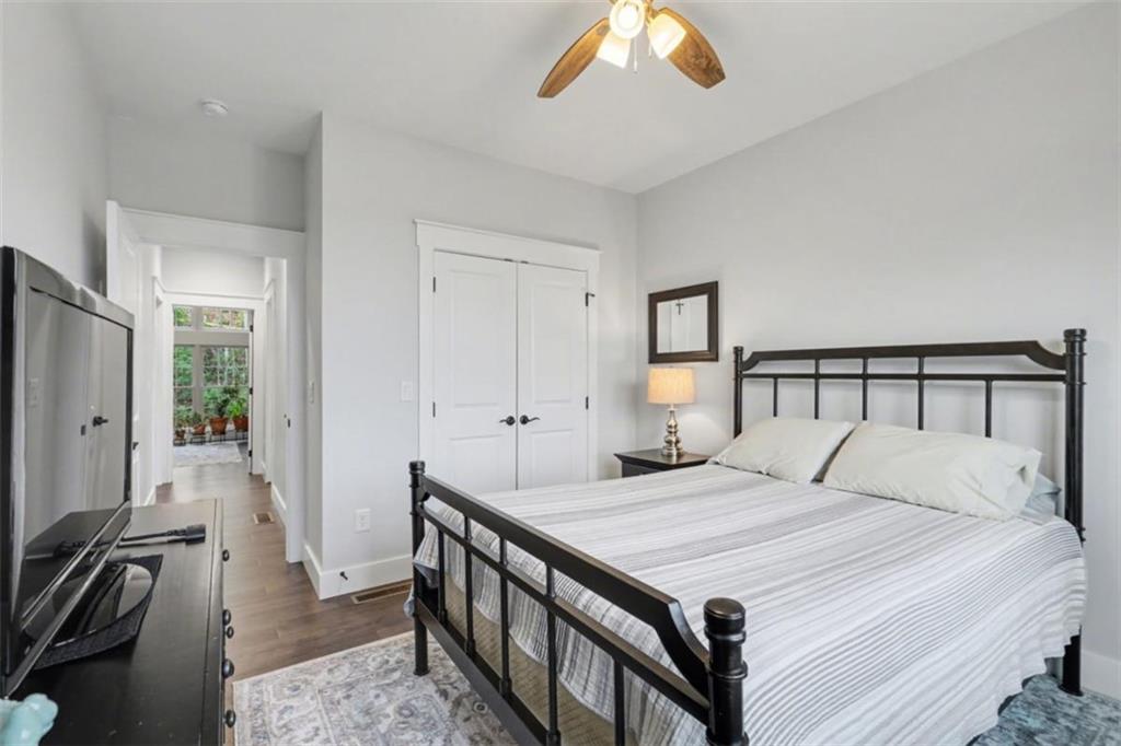 452 Chestnut Mountain Road Blairsville, GA 30512 - Photo 22 of 77 a bedroom with a bed and a chandelier