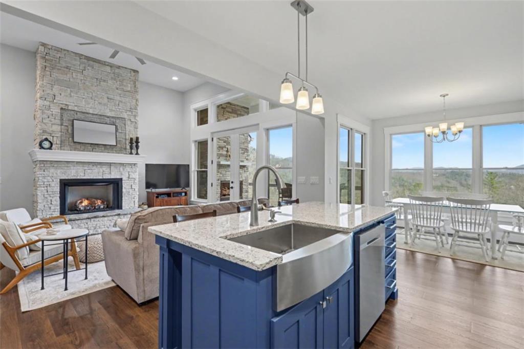 452 Chestnut Mountain Road Blairsville, GA 30512 - Photo 29 of 77 a kitchen with a sink a counter top space and living room view