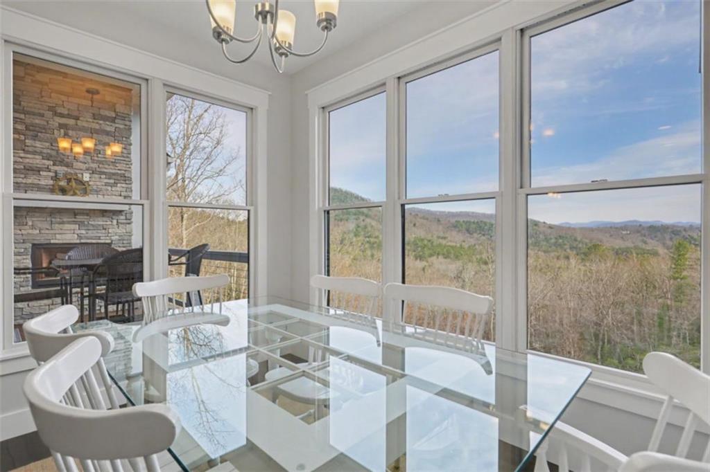 452 Chestnut Mountain Road Blairsville, GA 30512 - Photo 4 of 77 a view of a dining room with furniture large windows and wooden floor