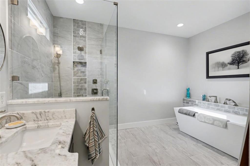 452 Chestnut Mountain Road Blairsville, GA 30512 - Photo 41 of 77 a bathroom with a bathtub sink and mirror