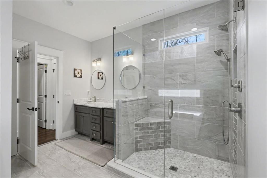 452 Chestnut Mountain Road Blairsville, GA 30512 - Photo 42 of 77 a bathroom with a shower mirror and sink