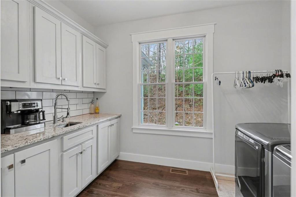 452 Chestnut Mountain Road Blairsville, GA 30512 - Photo 47 of 77 a kitchen with stainless steel appliances granite countertop a stove a sink and a white cabinets