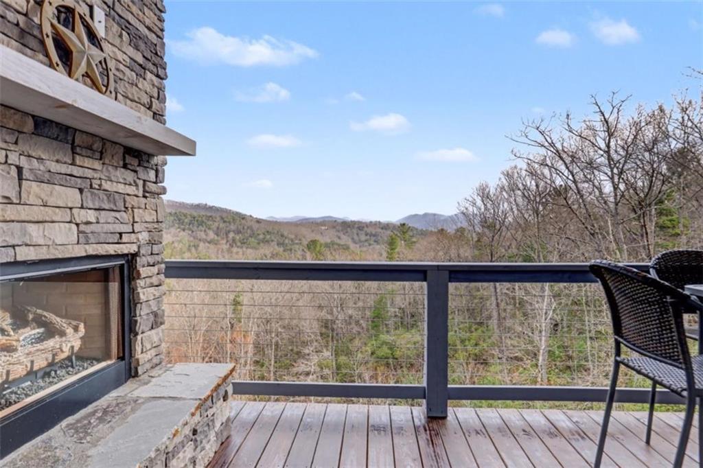 452 Chestnut Mountain Road Blairsville, GA 30512 - Photo 5 of 77 a view of balcony with wooden floor and fence