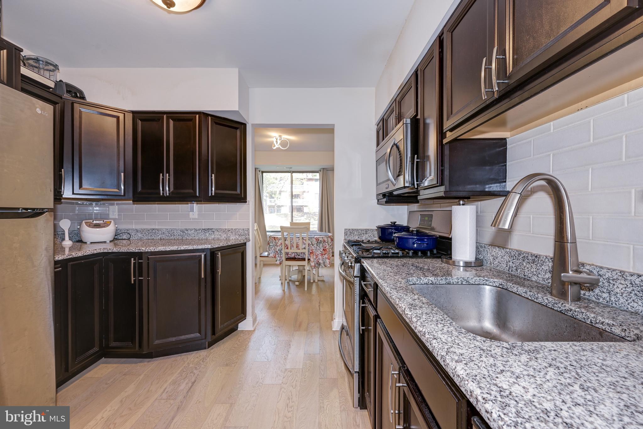 126 Kirkbride Road Voorhees, NJ 08043 - Photo 5 of 25 a kitchen with stainless steel appliances granite countertop a sink stove and cabinets