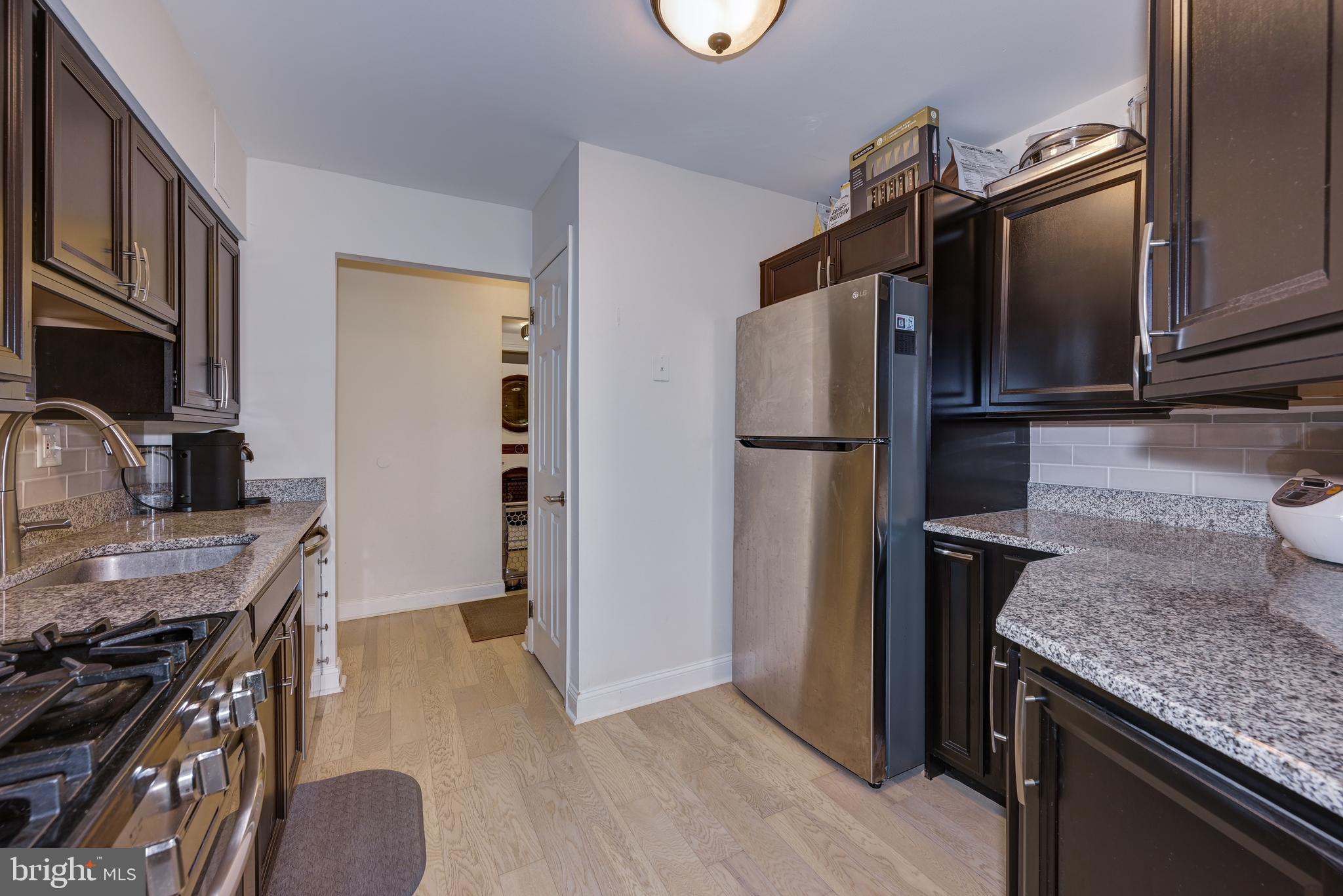 126 Kirkbride Road Voorhees, NJ 08043 - Photo 7 of 25 a kitchen with granite countertop a refrigerator stove and oven