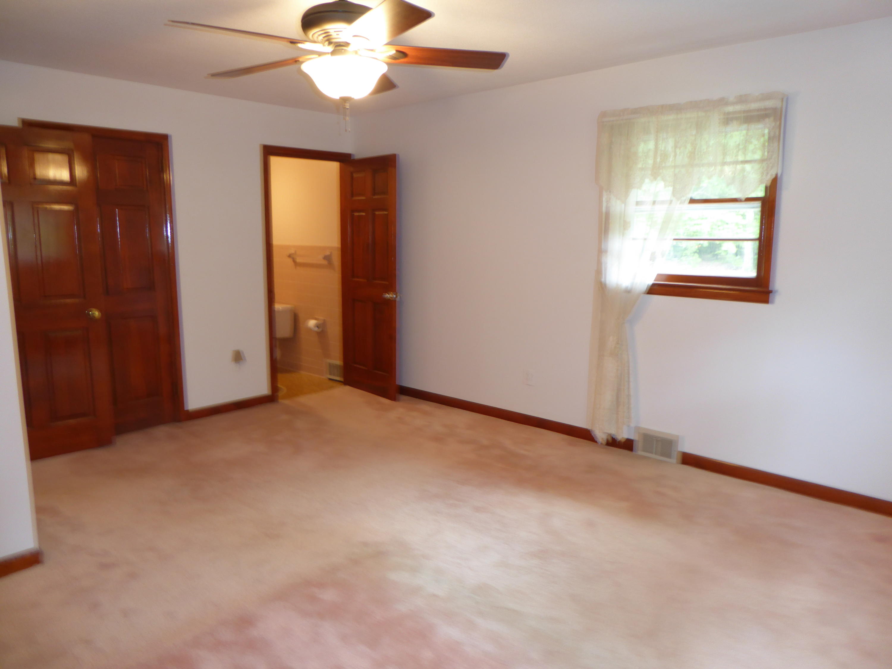 10454 Henry Road Henry, VA 24102 - Photo 14 of 72 an empty room with windows and chandelier fan