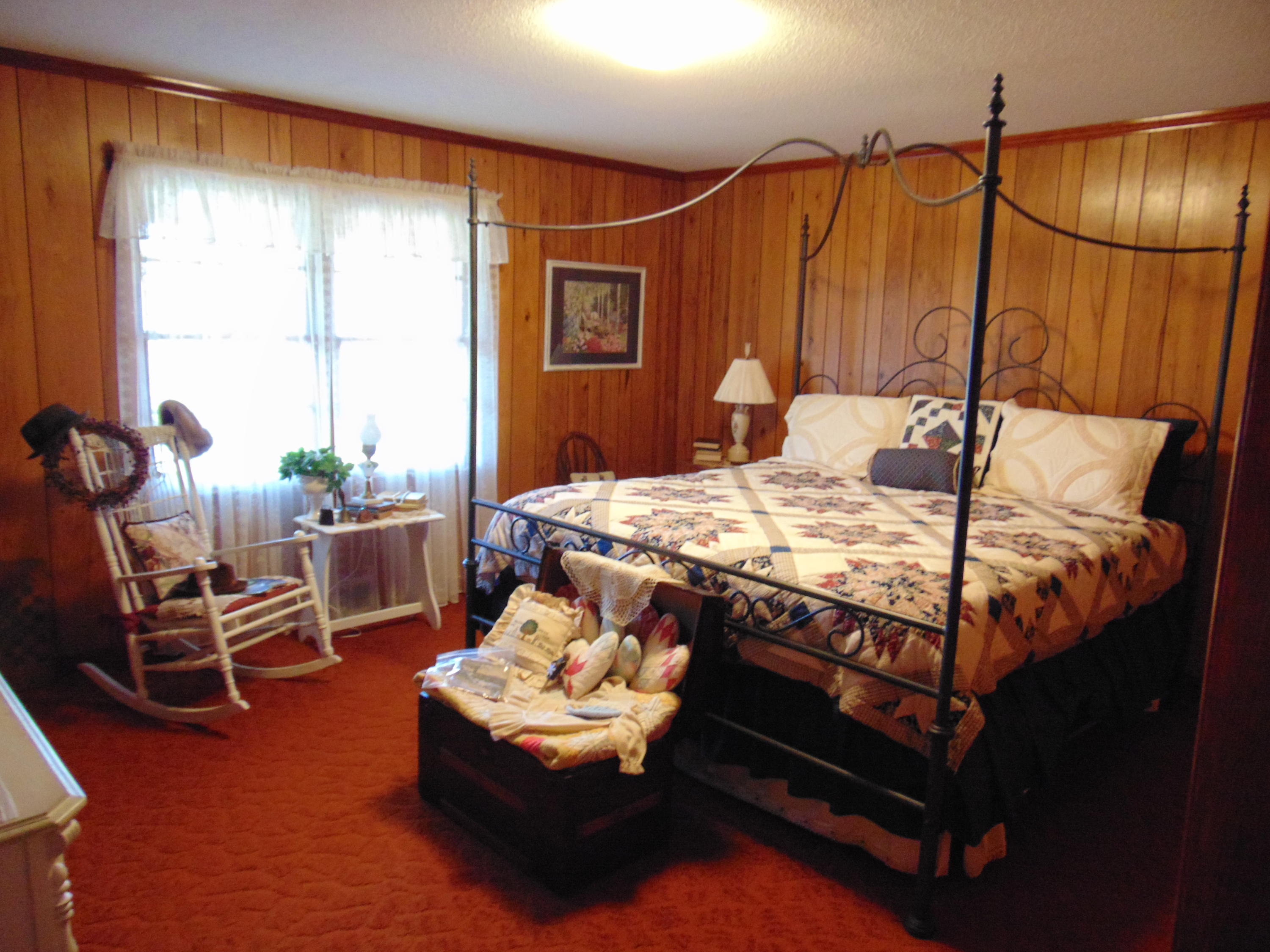 10454 Henry Road Henry, VA 24102 - Photo 17 of 72 a bed sitting in a bedroom next to a window