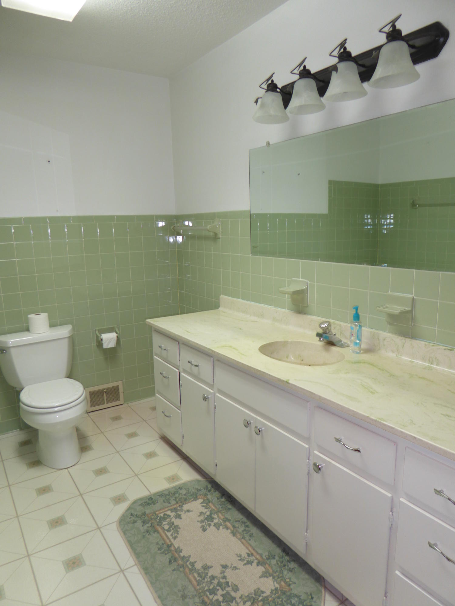 10454 Henry Road Henry, VA 24102 - Photo 23 of 72 a bathroom with a granite countertop toilet sink and mirror