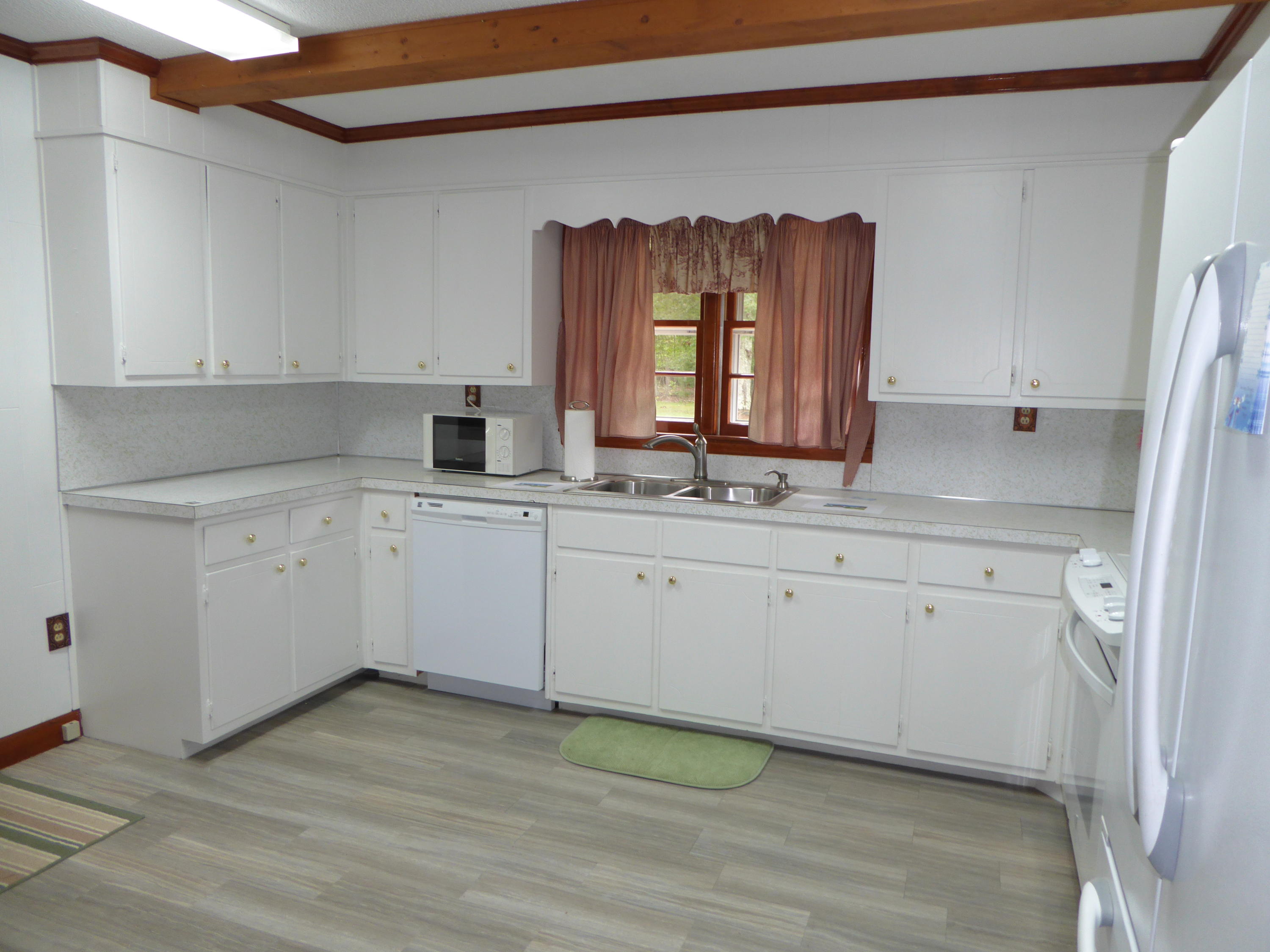 10454 Henry Road Henry, VA 24102 - Photo 51 of 72 a view of cabinets a wooden floor and a sink