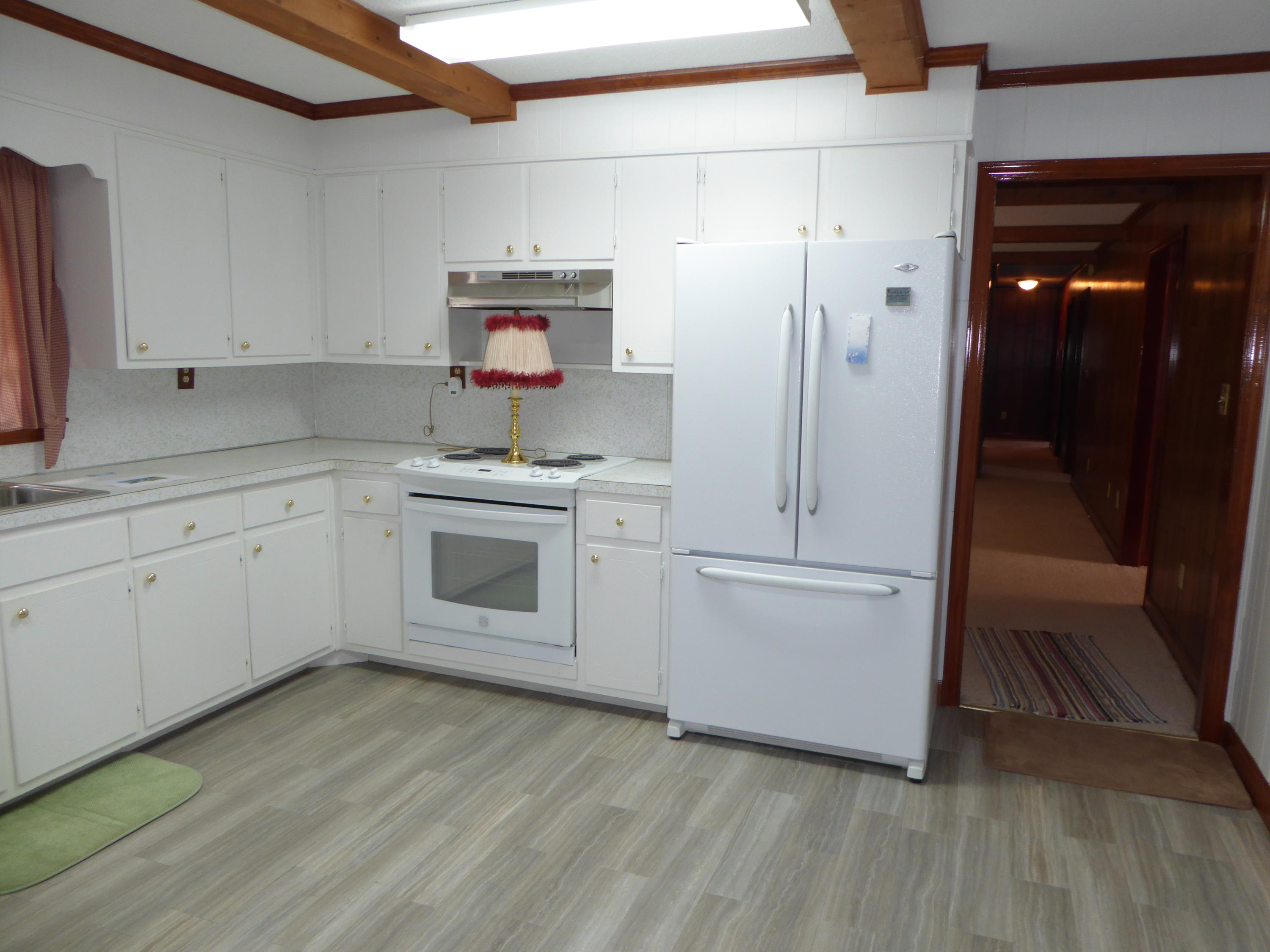 10454 Henry Road Henry, VA 24102 - Photo 52 of 72 a kitchen with white cabinets and white appliances